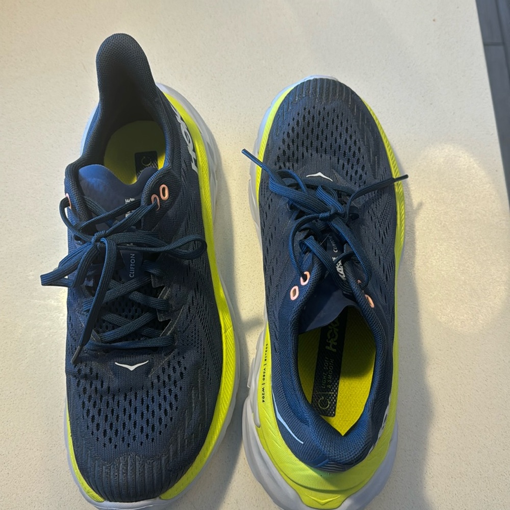 Hoka blue and bright yellow sneakers.